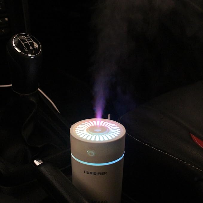 Aroma therapy diffuser releasing mist with essential oils for a relaxing home atmosphere.